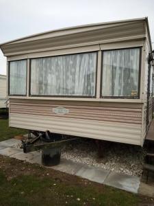 a mobile home sitting on a pile of gravel at L&g FAMILY HOLIDAYS 8 BERTH CORAL BEACH JOHN FAMILYS ONLY AND LEAD PERSON MUST BE OVER 30 in Ingoldmells