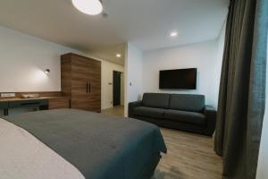 pokój hotelowy z łóżkiem i kanapą w obiekcie Lidový dům Opava w Opawie