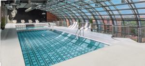 a large swimming pool on a building at Super-Apartamenty City Park I BASEN, SAUNA in Poznań