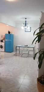 a dining room with a table and a blue refrigerator at Santo Cristo House in Ponta Delgada