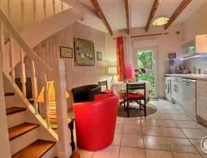 a kitchen with a staircase and a table and chairs at Gîtes Air Marin in Becléguer