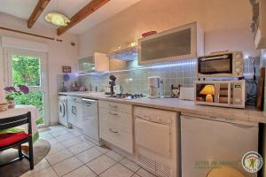 a kitchen with a stove and a microwave at Gîtes Air Marin in Becléguer +9 photos