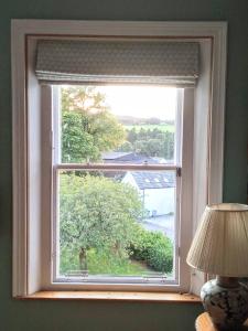 a window with a view of a tree at Kirkview House in Moffat