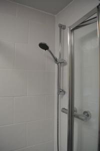 a shower with a glass door in a bathroom at Riverside House in Hamble