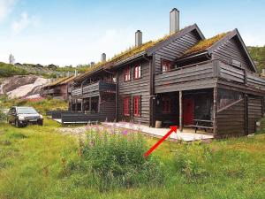 a house with a red arrow in front of it at 6 person holiday home in SERAL in Åseral