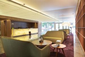 a lobby with couches and tables and chairs at Dazzler by Wyndham Montevideo in Montevideo