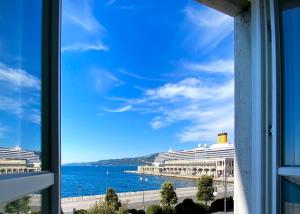 a window view of the ocean and cruise ships at Five Flowers Guest House in Trieste