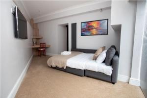 a bedroom with a bed and a television in it at The Vanguard York - Private Residence in York