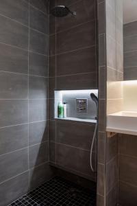 a bathroom with a shower with a sink at The Vanguard York - Private Residence in York