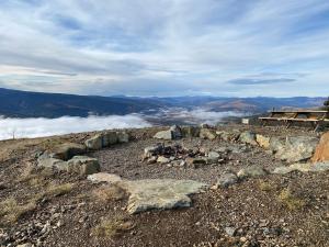 a view from the top of a mountain with clouds at Dawson Lodge in Dawson City