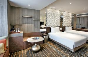 a hotel room with a bed and a table at Crowne Plaza Changi Airport, an IHG Hotel in Singapore