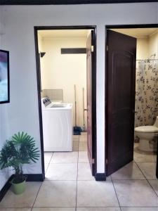 a bathroom with a toilet and a sink at Kubo Apartment Private 2 Bedrooms 5 mins SJO Airport with AC in Alajuela City