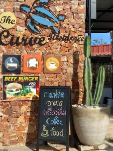 a restaurant with a cactus in front of a building at The Curve Residence in Khao Tao