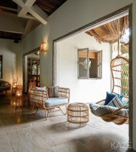 a living room with wicker chairs and a couch at Sailing Club Resort Mui Ne in Mui Ne
