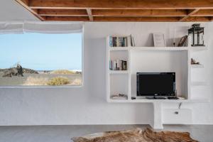 a living room with a tv on a white wall at El Loft in Famara