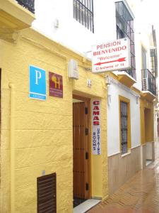 a building with a sign on the side of it at Pensión Bienvenido in Seville
