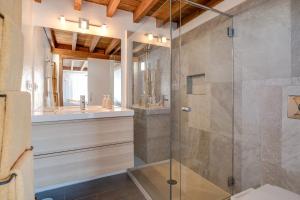 a bathroom with a glass shower and a sink at El Loft in Famara +14 photos