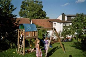 a group of children playing on a swing set in a yard at Gasthof Zum Hohen Lohr in Battenhausen