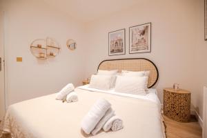 a bedroom with a bed with towels on it at Beautiful Apartments in le "Haut Marais" in Paris