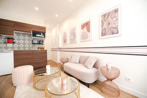 a living room with a couch and two tables at Beautiful Apartments in le "Haut Marais" in Paris