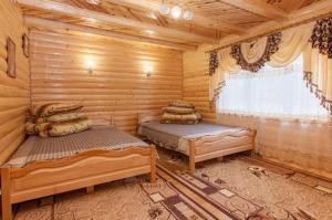 ヤレムチャにあるKarpatskyi Diamantのログキャビン内のベッドルーム1室(ベッド2台付)