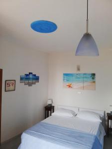 a bedroom with a bed and a blue ceiling at Hotel Sibilla Residence in Pozzuoli
