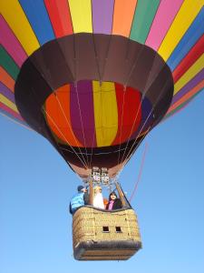 a group of people riding a colorful hot air balloon at Winthrop Inn in Winthrop