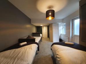 a row of beds in a room with a light at Large Townhouse in the Heart of Galway No 11 in Galway