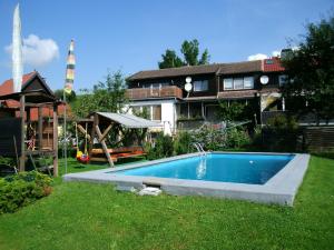 a swimming pool in the yard of a house at Ferienwohnung in Harzungen