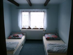 two beds in a room with a window at Ferienwohnung in Harzungen +7 photos
