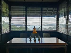 a dining room with a table with two figurines on it at Flower Hill Villa Bali 'Villa Bukit Berbunga Bali' in Bedugul