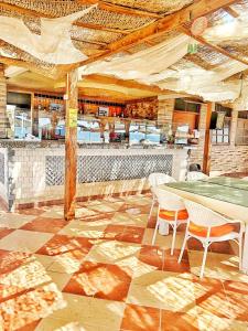 a restaurant with a table and chairs and a bar at Ganet Sinai Resort in Dahab