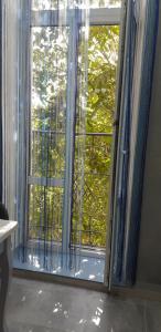a large window with blue curtains in a room at Apartment on Soborna 91 in Vinnytsya