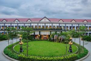 a building with two statues of elephants in the courtyard at MAYFAIR Tea Resort in Siliguri
