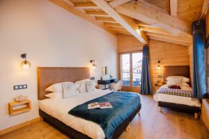 a bedroom with a large bed and a desk at Chalet Harmonie in Morzine