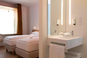 Postel nebo postele na pokoji v ubytování Best Western Hotel Spinnerei Linz