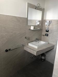 a bathroom with a sink and a mirror at Hotel Nuovo in Milan