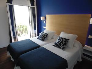 Postel nebo postele na pokoji v ubytování Hotel Llorca