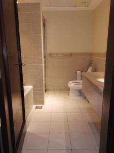 a bathroom with a toilet and a sink at نزل المارينا - Marina Resident in King Abdullah Economic City