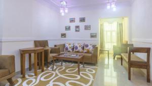 a living room with a couch and a table at Al Saif Grand Hotel By Clove International in Muscat