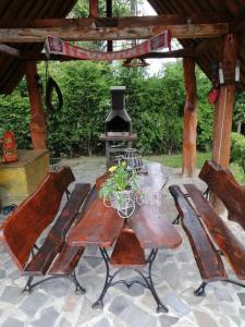a wooden table with two chairs and a stove at Domek u Magdy in Zakopane
