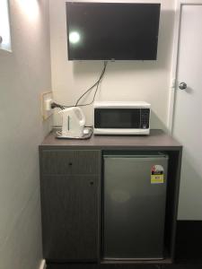 a white microwave sitting on top of a wooden table at Bradman Motor Inn in Cootamundra