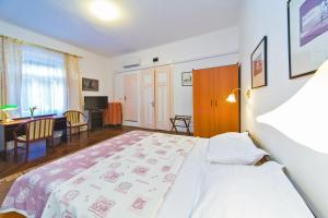 a bedroom with a bed and a dining room with a table at B&B Sesame Inn in Dubrovnik