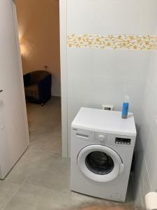 a white washing machine in a room with a hallway at PREMIUM COMFORT PRIVATE in Beer Sheva