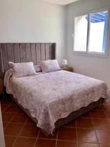 a bedroom with a large bed with a window at Brand new Beautiful Vacation house - Family Only in Cabo Negro +4 photos