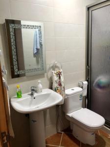a bathroom with a toilet and a sink at Brand new Beautiful Vacation house - Family Only in Cabo Negro