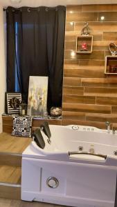 a bathroom with a white sink and a mirror at MANOIR AUX trois charmes in Ronchamp