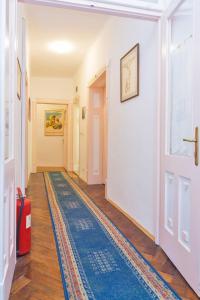 a hallway with a door and a rug on the floor at B&B Sesame Inn in Dubrovnik