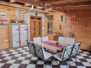 a wooden room with a wooden table and chairs at Fortuna Vendégház in Kiskunhalas
