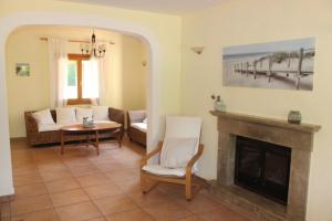 a living room with a fireplace and a couch at Finca Verde in Llucmajor